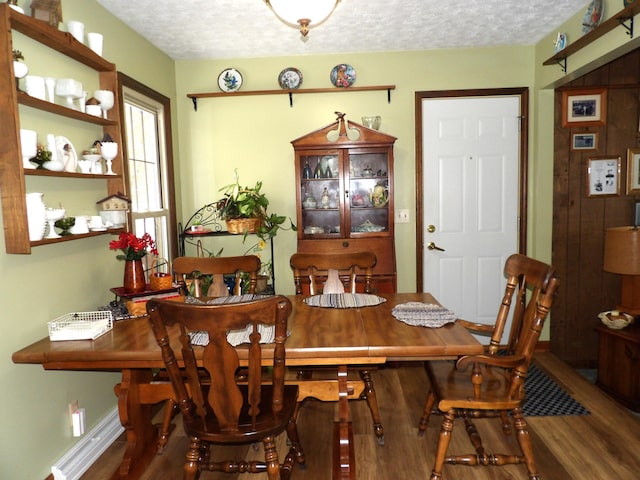 dining area featuring hardwood / wood-style floors and a textured ceiling