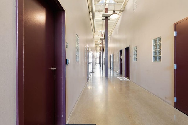 corridor featuring a towering ceiling