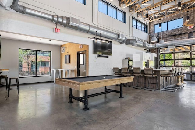 rec room featuring visible vents, concrete floors, a towering ceiling, and pool table