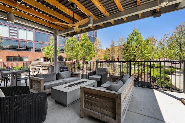 view of patio / terrace with an outdoor living space with a fire pit