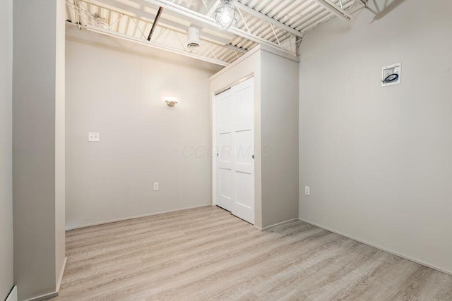 interior space with baseboards and wood finished floors
