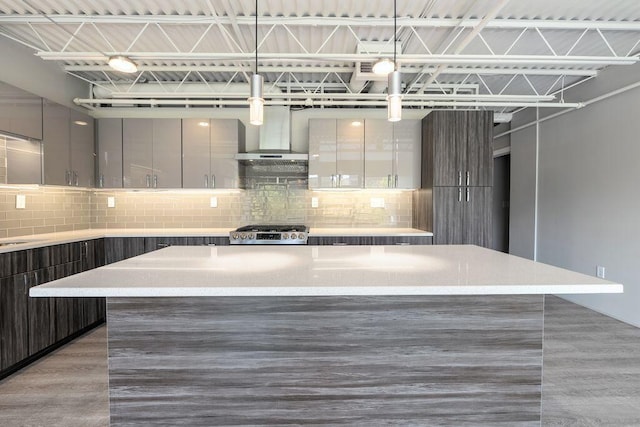 kitchen with a center island, decorative backsplash, modern cabinets, and range