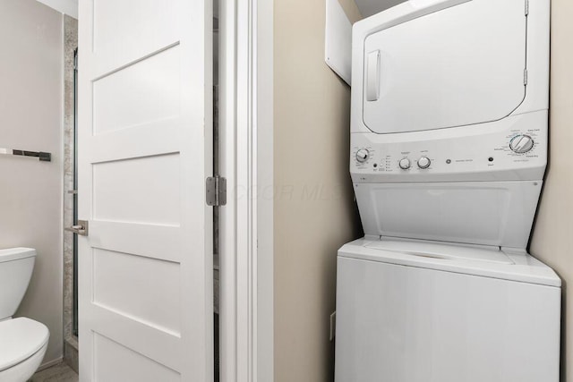 washroom featuring laundry area and stacked washer / dryer