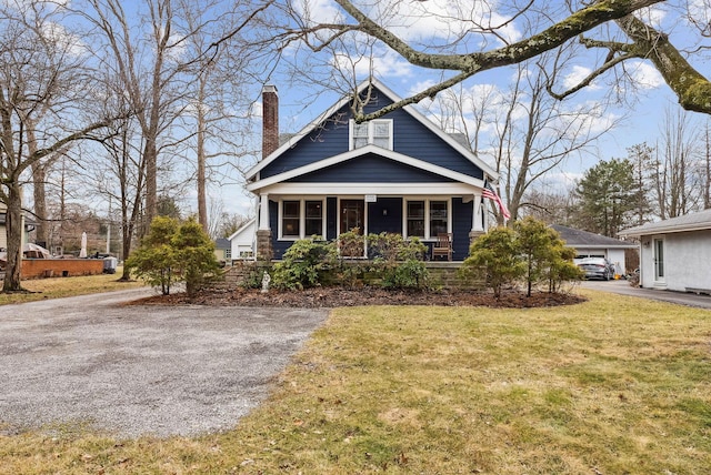 view of front of property with a chimney and a front yard