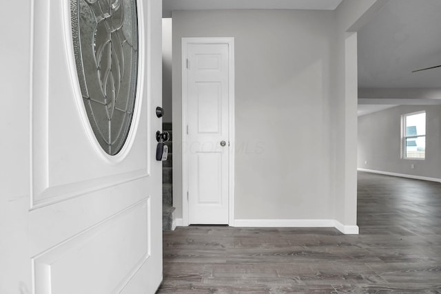 foyer entrance featuring dark wood-style floors and baseboards