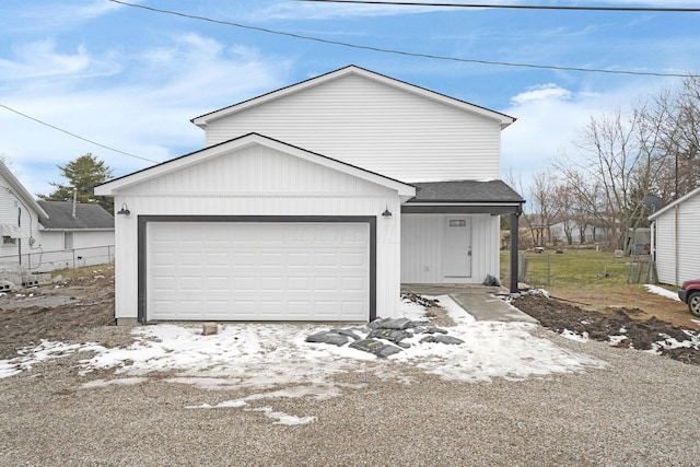 view of front of home with a garage and a shingled roof