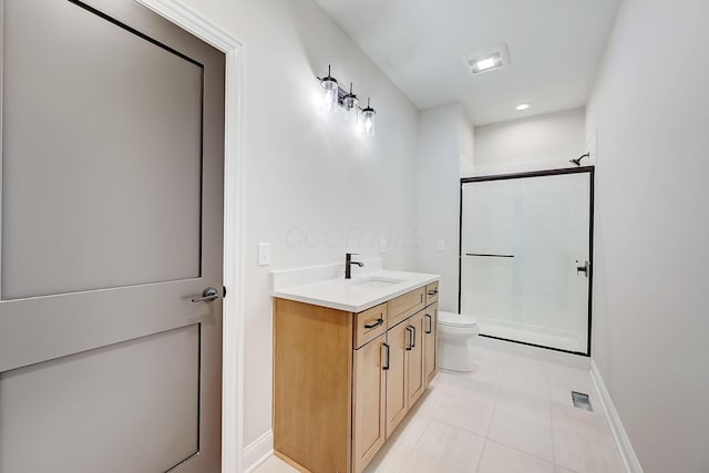 full bath featuring toilet, vanity, baseboards, tile patterned floors, and a stall shower