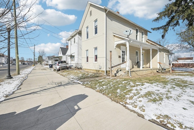 view of snow covered exterior featuring a porch