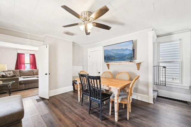 dining area featuring baseboards, visible vents, dark wood-type flooring, and ornamental molding