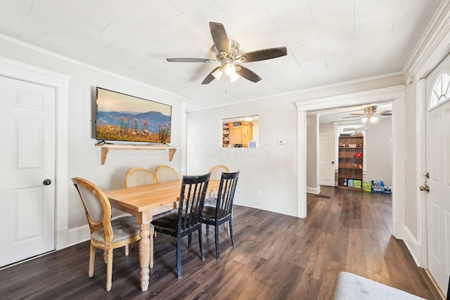 dining area featuring crown molding, a ceiling fan, dark wood-type flooring, and baseboards