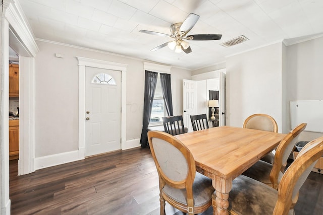 dining area with crown molding, visible vents, dark wood-type flooring, and baseboards