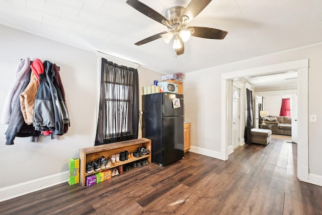 interior space featuring baseboards, dark wood-style floors, and ornamental molding