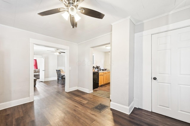 hall with crown molding, visible vents, dark wood-type flooring, and baseboards