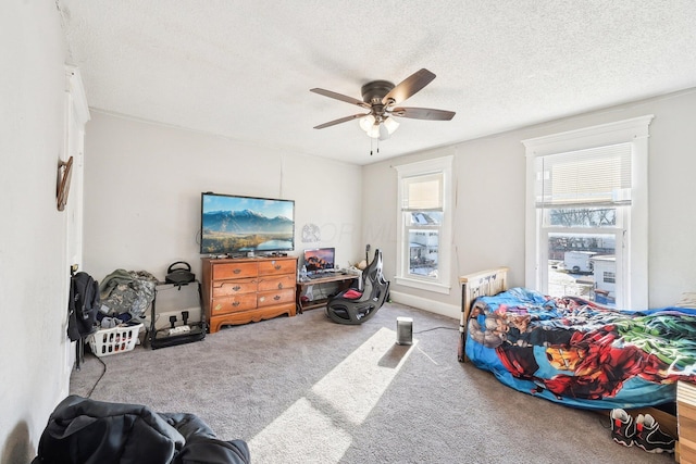 carpeted bedroom with a ceiling fan and a textured ceiling