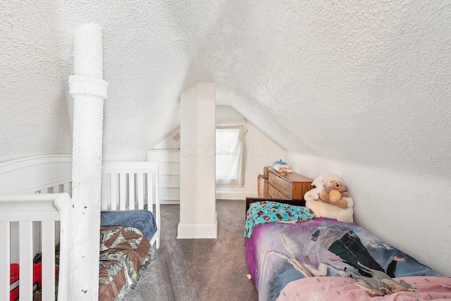 bedroom featuring lofted ceiling, dark carpet, and a textured ceiling