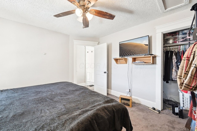 bedroom featuring a ceiling fan, baseboards, carpet floors, a textured ceiling, and a closet