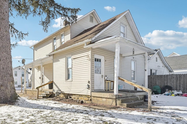 view of front of home with fence, a porch, and entry steps