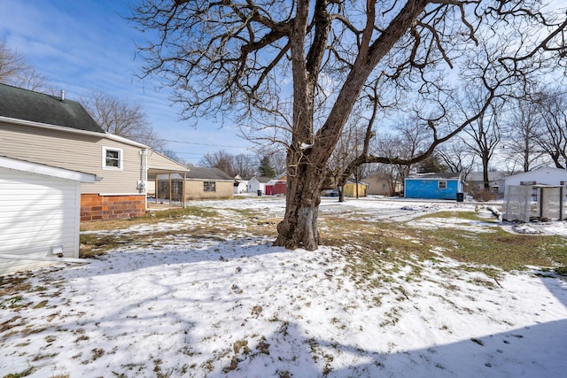 yard layered in snow with a residential view