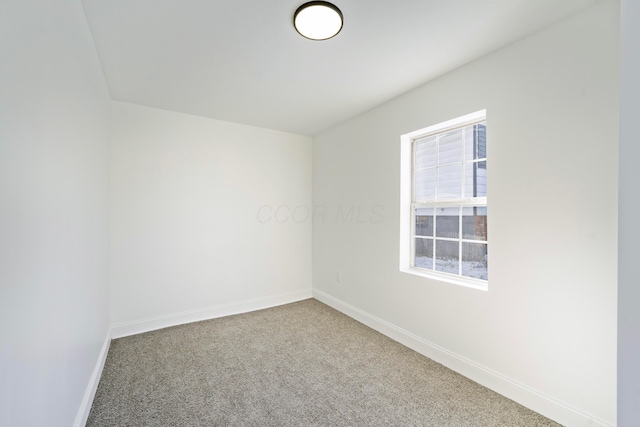 carpeted spare room with baseboards