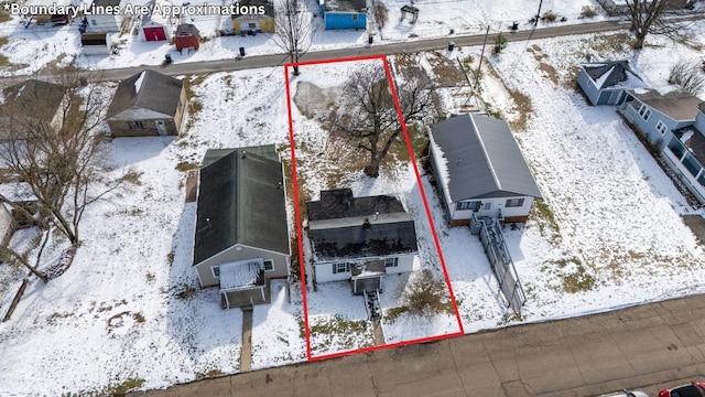 snowy aerial view featuring a residential view