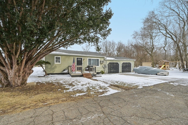 ranch-style home with driveway and a garage