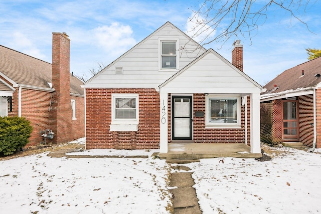 bungalow-style home with brick siding