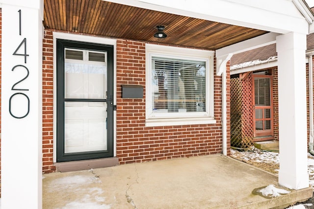 property entrance with brick siding