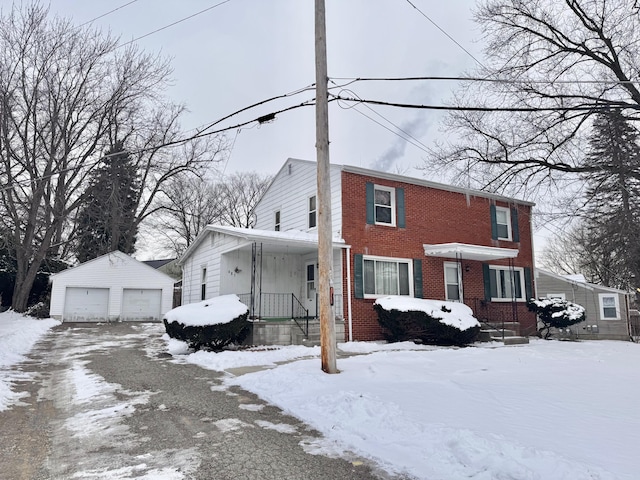 view of front of home featuring a garage and an outbuilding