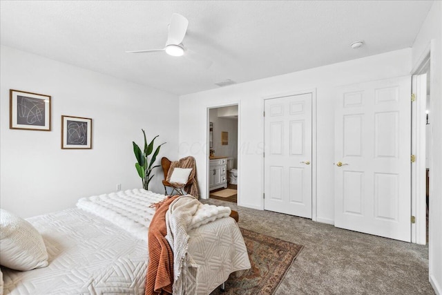 bedroom with visible vents, baseboards, ensuite bath, ceiling fan, and carpet floors