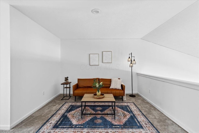 living area with lofted ceiling, carpet, and baseboards