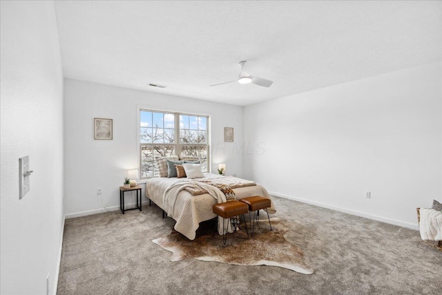 carpeted bedroom with visible vents, a ceiling fan, and baseboards