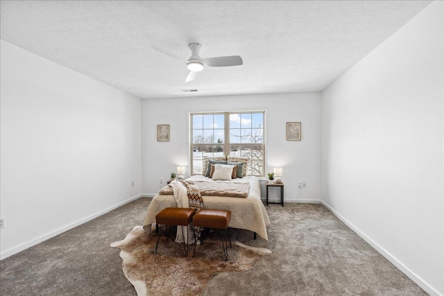 bedroom featuring carpet, visible vents, baseboards, and a textured ceiling