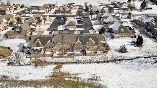 snowy aerial view with a residential view