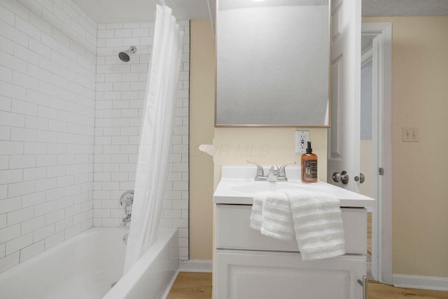 bathroom featuring shower / bath combo with shower curtain and vanity