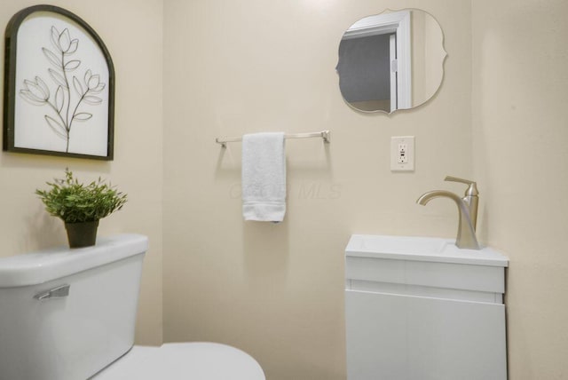 bathroom with toilet and vanity