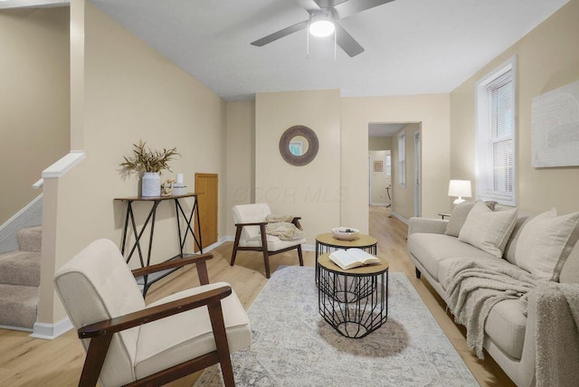 living room with light hardwood / wood-style floors and ceiling fan