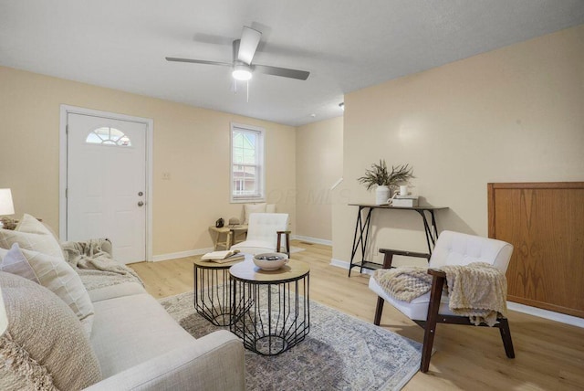 living room featuring ceiling fan and light hardwood / wood-style floors