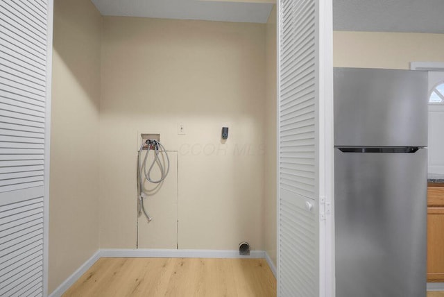 laundry area featuring hookup for a washing machine and light wood-type flooring