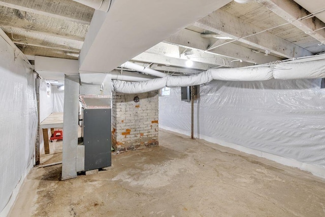 basement with heating unit and electric panel