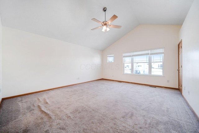 carpeted spare room with ceiling fan, high vaulted ceiling, visible vents, and baseboards