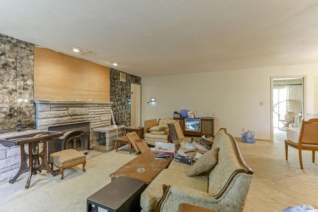 carpeted living room with a textured ceiling and a fireplace