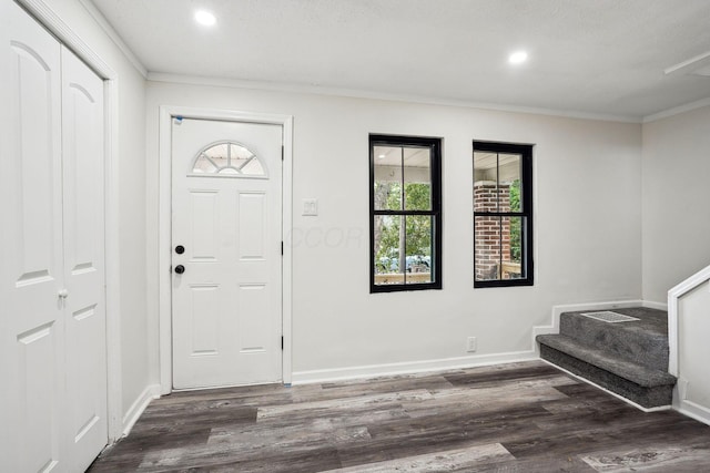 entryway featuring dark hardwood / wood-style flooring and ornamental molding