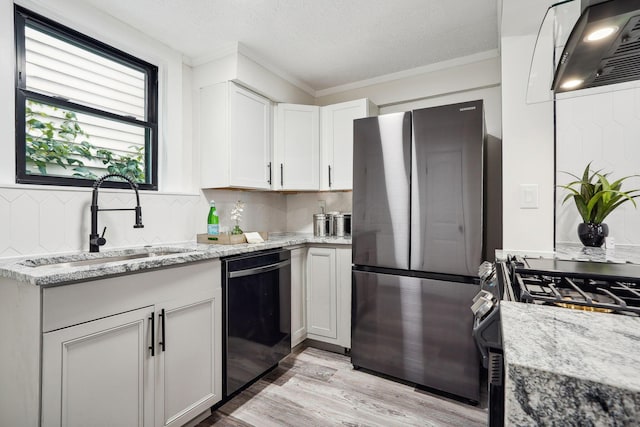 kitchen featuring white cabinetry, black dishwasher, stainless steel refrigerator, light stone countertops, and sink