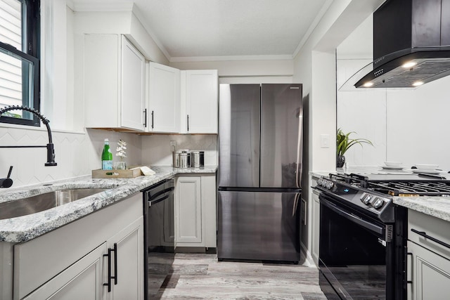 kitchen with sink, black dishwasher, exhaust hood, range with gas cooktop, and stainless steel refrigerator