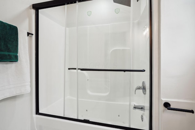 bathroom featuring shower / bath combination with glass door