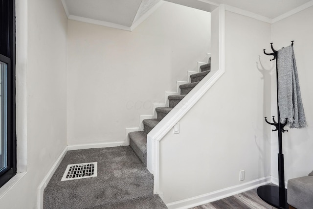 stairs featuring crown molding