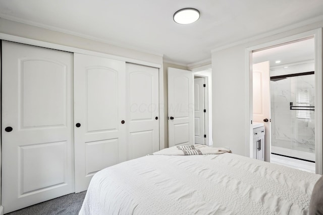 bedroom with crown molding, a closet, and ensuite bathroom