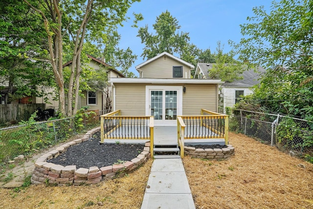 back of property featuring a wooden deck