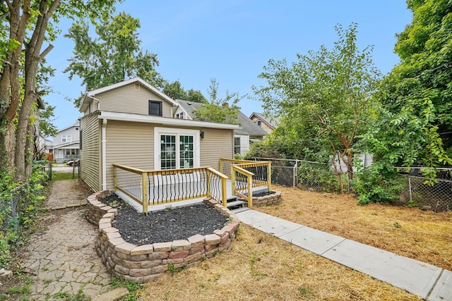 rear view of house with a wooden deck