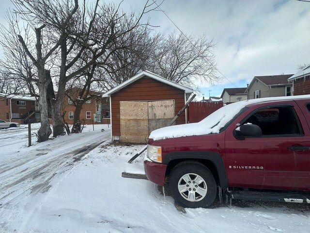 235 Oak St, Marion, OH 43302 - view of snow covered exterior with a garage and an outdoor structure